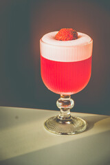 A Strawberry Sorbet cocktail made with ipnk gin, strawberry, lemon in a glass