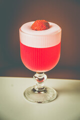 A Strawberry Sorbet cocktail made with ipnk gin, strawberry, lemon in a glass