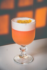 A Coconut Campari cocktail made with.Campari, gin, coconut, lemon