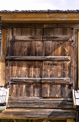 Old wooden shutters in a country house in the countryside.