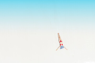 Aerial view of summer with young woman relaxation  sunbath as lying on the beach  in Maldives