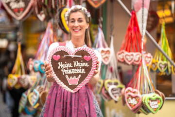 Traditional costume dirndl woman with Lebkuchenherz at Bavarian folk festival Germany