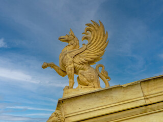 A griffin statue embodying mythological grandeur and classical artistry, atop the National Academy of Athens, Greece.