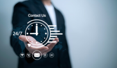 A businessman holds a digital clock and contact icons, representing 24/7 customer support and communication service