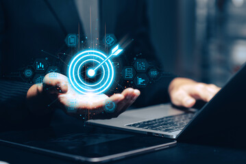 Cybersecurity login and data protection concept: A user's hands type on a laptop keyboard, with a glowing shield icon containing a padlock and a virtual login form for username and password.