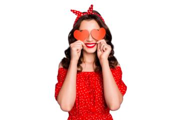 Pretty lady in playful mood hiding eyes with little heart figure cards wear red dress isolated purple background