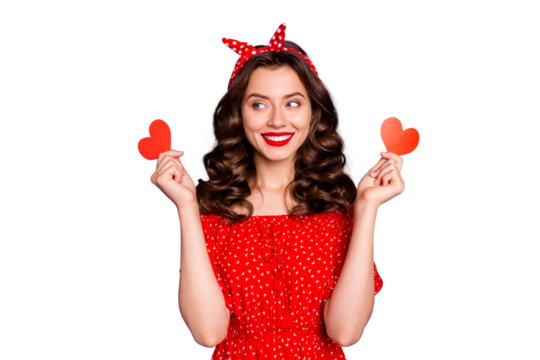 Beautiful lady holding little heart figure cards in arms wear red dress isolated purple background