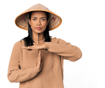 Young Filipina with Vietnamese hat showing a timeout gesture.