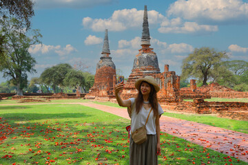 Asian woman enjoy her visit temple at Ayutthaya ancien city in Thailand