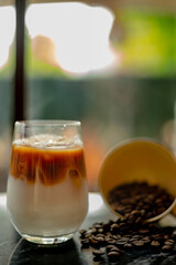 ice cold espresso latte on the table with coffee beans.
