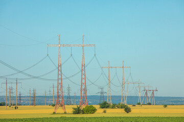High-voltage power line in the field. Electricity pylons in the evening. Electric tower. Power...