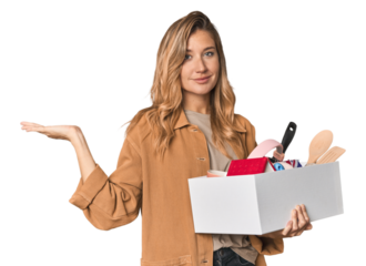 Young Caucasian blonde moving with a box showing a copy space on a palm and holding another hand on waist.