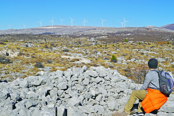 Man and green ecology: a tourist sits in the mountains near Mostar (Bosnia and Herzegovina) and...