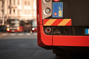 Red bus for public transportation parked on a station.