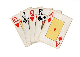 A poker hand of vintage playing cards isolated on a white background.