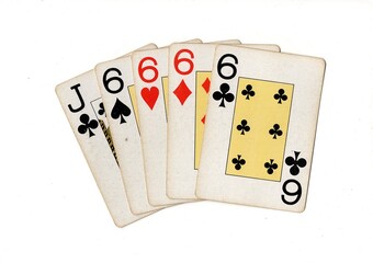 A poker hand of vintage playing cards isolated on a white background.