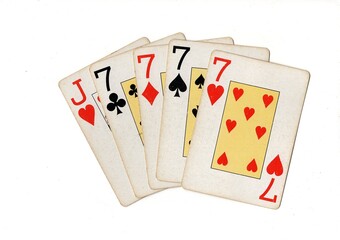 A poker hand of vintage playing cards isolated on a white background.