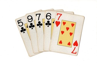 A poker hand of vintage playing cards isolated on a white background.