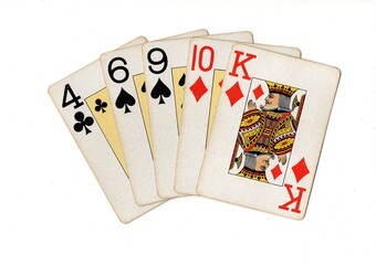 A poker hand of vintage playing cards isolated on a white background.
