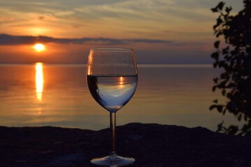 Glass of white wine at sunset.