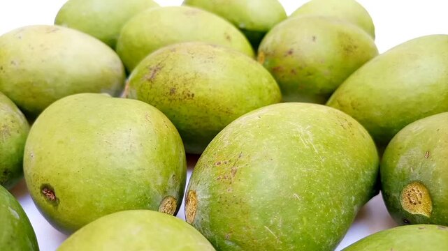 Fresh green mango fruits on white background moving, tropical fruit, unripe mangoes for pickle