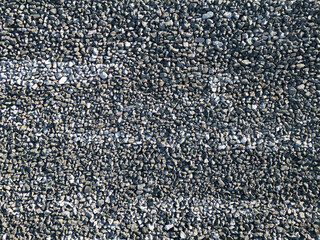 Fototapeta premium Abstract texture and background of grey crushed stone covering the surface of a rock-fill hydropower dam in the mountains of Norway.
