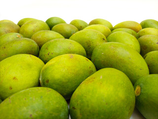 Fresh green mango fruits on white background, tropical fruit, unripe mangoes for pickle