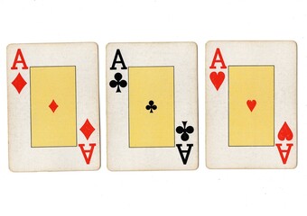 Vintage playing cards showing three of the same value on a white background.