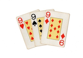 Obraz premium Vintage playing cards showing three of the same value on a white background.