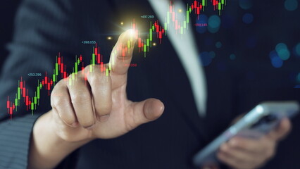 Financial Analysis at Hand: A person's hand deftly interacts with a smartphone displaying a dynamic...