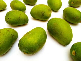 Fresh green mango fruits on white background, tropical fruit, unripe mangoes for pickle