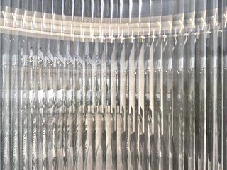 Texture of fluted glass, or striped glass, with the refraction of lights behind it. Fluted glass is...
