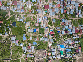 Fototapeta premium Aerial view of Zanzibar showing colorful houses and lush vegetation