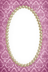 Oval frame of pearls on a background of pink pattern close-up