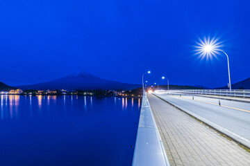 Enjoying the nighttime lake view of Mount Fuji from the Kawaguchiko Ohashi Bridge.Japan.