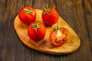 Fresh tomatoes on wooden board