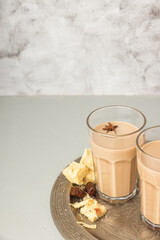 Cups of Indian masala chai on a metal try