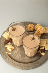 Cups of Indian masala chai on a metal try