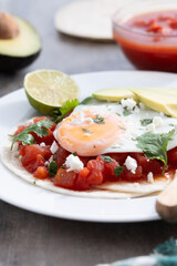 Huevos Rancheros. Traditional Mexican breakfast on wooden table