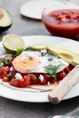 Huevos Rancheros. Traditional Mexican breakfast on wooden table