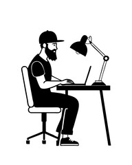 Young man working at a desk with a laptop and a desk lamp in a modern workspace setting