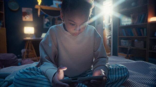 Black girl in pyjamas looking at phone screen sitting on bed in dark room at night feeling suspicious while mysterious creature opening door trying to sneak up behind her and walking away unnoticed