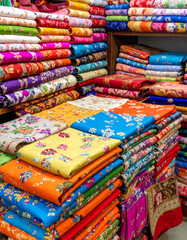 Hand-stitched Nakshi Kantha quilts, with their vibrant patterns, are displayed, showcasing intricate folk embroidery and storytelling.