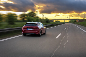 Car on highway. Driving at sunset. Road through nature.