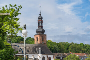 The upper part of the castle church with a dome and a rooster on the spire in Saarbrucken Germany