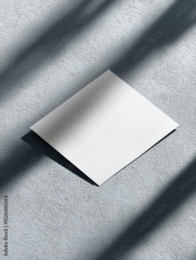 Poster blank white paper on textured wall with shadow, ideal for mockups and creative presentation, represe
