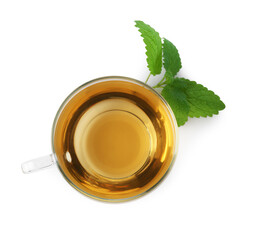 Aromatic lemon balm tea in glass cup and fresh leaves isolated on white, top view