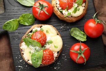 Tasty stuffed mushrooms served on wooden table, top view