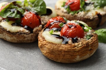 Tasty stuffed mushrooms served on table, closeup