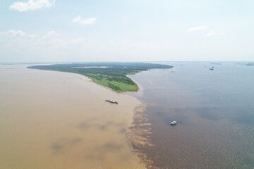 Majestic river confluence in the Amazon region on a sunny day